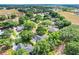 Wide aerial view of the neighborhood and surrounding area, showing a home nestled among trees at 10851 Lantana Crst, Clermont, FL 34711