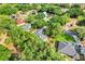 Aerial view showcasing the property boundaries, lush trees, and the surrounding neighborhood at 10851 Lantana Crst, Clermont, FL 34711