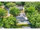 Overhead shot showing the property with mature trees, a long driveway, and lush greenery at 10851 Lantana Crst, Clermont, FL 34711