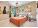 Cozy bedroom with neutral walls, ceiling fan, window view and guitar decor at 10851 Lantana Crst, Clermont, FL 34711