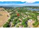 Scenic aerial view of the community, showing homes among trees and near a lake at 10851 Lantana Crst, Clermont, FL 34711
