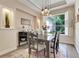 Charming dining room with a wooden table, decorative lighting, and large windows at 10851 Lantana Crst, Clermont, FL 34711