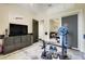 Exercise room with weight-lifting equipment, TV, storage cabinets, and access to another room at 10851 Lantana Crst, Clermont, FL 34711