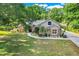 Inviting single-story home featuring a well-maintained lawn, stone detailing, and tasteful landscaping at 10851 Lantana Crst, Clermont, FL 34711