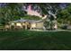 Beautifully landscaped single-Gathering home with stone accents, red door and mature trees in a serene setting at 10851 Lantana Crst, Clermont, FL 34711