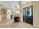 Elegant foyer featuring a decorative front door, stylish console table, and view into dining area at 10851 Lantana Crst, Clermont, FL 34711