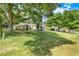 Charming single-story home with a large front lawn and mature trees at 10851 Lantana Crst, Clermont, FL 34711
