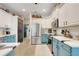 Spacious kitchen featuring stainless steel appliances, two-tone cabinets, and ample storage space at 10851 Lantana Crst, Clermont, FL 34711