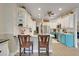 Open kitchen design with ample counter space, white cabinets, and stainless steel appliances at 10851 Lantana Crst, Clermont, FL 34711