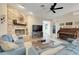 Cozy living room with stone fireplace, blue sofas, and a piano for Gathering gatherings at 10851 Lantana Crst, Clermont, FL 34711