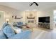 Cozy living room with a stone fireplace, large TV, and comfortable blue sofas at 10851 Lantana Crst, Clermont, FL 34711