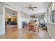 Open floor plan with a view to the living room and the office, including a workspace, table, and exposed brick at 10851 Lantana Crst, Clermont, FL 34711