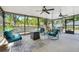 View of a screened-in patio with furniture, ceiling fans and backyard at 10851 Lantana Crst, Clermont, FL 34711
