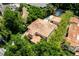 Stunning aerial view of a tile roof home with lush landscaping and a private pool in a desirable location at 1196 Lakeshore Dr, Mount Dora, FL 32757