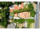 Bird's-eye view showcases the home's tile roof, sparkling pool, and surrounding greenery at 1196 Lakeshore Dr, Mount Dora, FL 32757