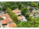 Expansive aerial view of home with tile roof, lush landscaping, and long driveway at 1196 Lakeshore Dr, Mount Dora, FL 32757
