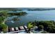 An aerial view showcases a waterfront community with docks, boats, and mature trees at 1196 Lakeshore Dr, Mount Dora, FL 32757