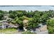 Aerial view of a home nestled amongst lush trees with a glimpse of the water in the distance at 1196 Lakeshore Dr, Mount Dora, FL 32757