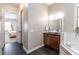 Beautiful bathroom featuring a vanity, soaking tub, and open doorway to bedroom at 1196 Lakeshore Dr, Mount Dora, FL 32757