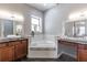 Well-lit bathroom with double vanities, soaking tub and tile floors at 1196 Lakeshore Dr, Mount Dora, FL 32757
