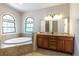 Bathroom featuring a soaking tub, double vanity and natural light at 1196 Lakeshore Dr, Mount Dora, FL 32757