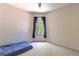 Minimalist bedroom featuring a comfortable mattress, large window, and neutral carpet at 1196 Lakeshore Dr, Mount Dora, FL 32757