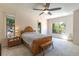 Bright bedroom with a wood bed frame, bench, bedside table, and natural lighting at 1196 Lakeshore Dr, Mount Dora, FL 32757