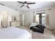 Bright bedroom with doors to the patio and white and wood dresser at 1196 Lakeshore Dr, Mount Dora, FL 32757