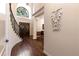 Spacious foyer with hardwood floors, a staircase, a high ceiling, and a decorative light fixture at 1196 Lakeshore Dr, Mount Dora, FL 32757