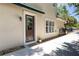 Inviting front entrance with a charming door, decorative plants, and a manicured stone garden at 1196 Lakeshore Dr, Mount Dora, FL 32757