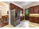 Spacious kitchen features stainless steel refrigerator, granite countertops, and wood cabinetry at 1196 Lakeshore Dr, Mount Dora, FL 32757