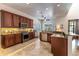 Eat-in kitchen with dark wood cabinets, granite countertops and travertine floors with decorative inlay at 1196 Lakeshore Dr, Mount Dora, FL 32757