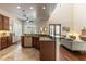 Kitchen offers stone counters, island with sink, wood cabinetry, and views to the living area at 1196 Lakeshore Dr, Mount Dora, FL 32757