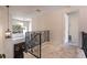 Bright landing with decorative iron railings and arched windows overlooking the front entrance at 1196 Lakeshore Dr, Mount Dora, FL 32757