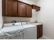 Bright laundry room featuring modern washer and dryer, plus built-in cabinetry and sink at 1196 Lakeshore Dr, Mount Dora, FL 32757