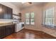 Spacious laundry room with modern appliances, shelving, and a bright window at 1196 Lakeshore Dr, Mount Dora, FL 32757