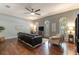 Comfortable living room features large windows, ceiling fan, and hardwood floors at 1196 Lakeshore Dr, Mount Dora, FL 32757