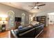Bright living room with ceiling fan, ample seating, and large windows with shutters at 1196 Lakeshore Dr, Mount Dora, FL 32757
