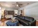 Open-concept living room with hardwood floors, built-in bookcases, and a comfortable couch at 1196 Lakeshore Dr, Mount Dora, FL 32757