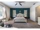 Stylish primary bedroom with a teal accent wall and natural light at 1196 Lakeshore Dr, Mount Dora, FL 32757