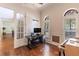Home office with hardwood floors, computer setup, two arched windows and glass french door at 1196 Lakeshore Dr, Mount Dora, FL 32757