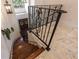 Elegant staircase with dark wood steps, decorative iron railings, and a view of the entryway below at 1196 Lakeshore Dr, Mount Dora, FL 32757