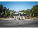 Corner building with an architectural staircase, lush plants, and vibrant street view at 1196 Lakeshore Dr, Mount Dora, FL 32757