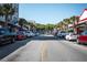 Charming street view with local shops and restaurants, framed by palm trees and parked cars at 1196 Lakeshore Dr, Mount Dora, FL 32757