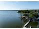 Scenic waterfront view featuring a pier, boats, and a charming lighthouse on a clear day at 1196 Lakeshore Dr, Mount Dora, FL 32757