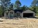 Unfinished single Gathering house has an attached garage with a white front door at 12 Guava Terrace Radl, Ocklawaha, FL 32179
