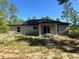 Unfinished single Gathering house shows the back patio and simple window trim at 12 Guava Terrace Radl, Ocklawaha, FL 32179