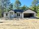 Unfinished single Gathering house has an attached garage with a white front door at 12 Guava Terrace Radl, Ocklawaha, FL 32179