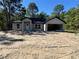 Unfinished single Gathering house has an attached garage with a white front door at 12 Guava Terrace Radl, Ocklawaha, FL 32179