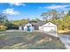 Updated single Gathering house with black and white trim and a blue front door at 12 Guava Terrace Radl, Ocklawaha, FL 32179